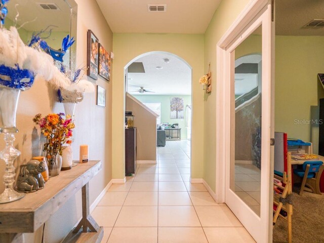 hall featuring light tile floors