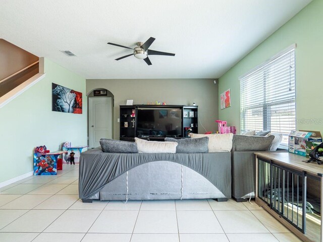 living room featuring ceiling fan and light tile flooring