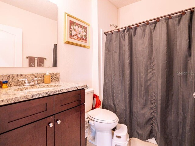 bathroom featuring vanity and toilet