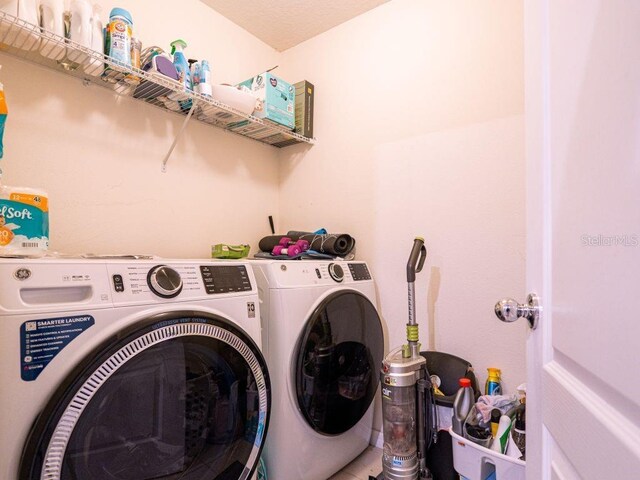 clothes washing area with separate washer and dryer