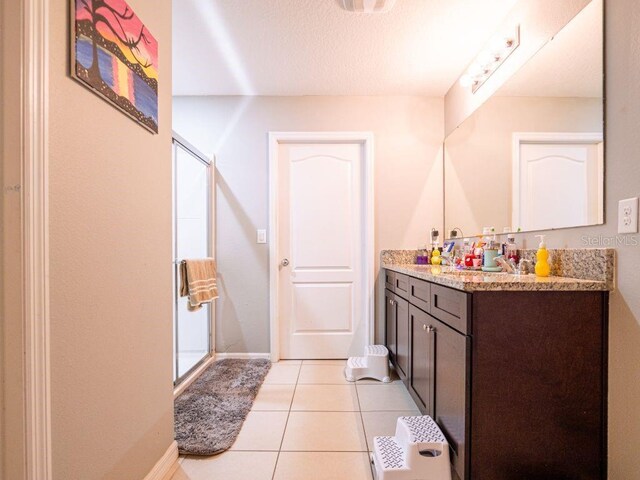 bathroom with tile flooring and vanity