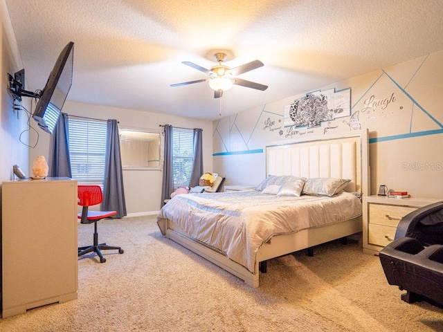 carpeted bedroom featuring a textured ceiling and ceiling fan