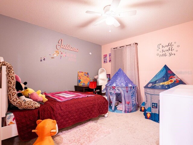 bedroom with a textured ceiling, carpet floors, and ceiling fan