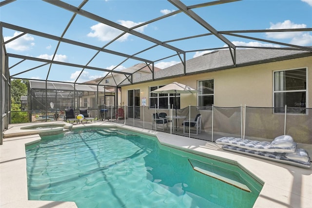 view of swimming pool with an in ground hot tub, a patio, and glass enclosure