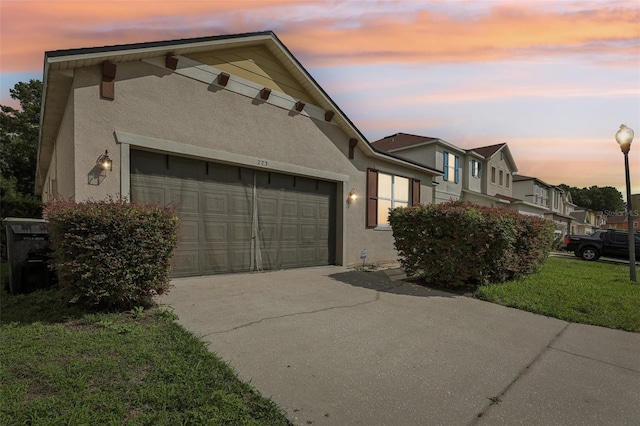 property exterior at dusk featuring a garage