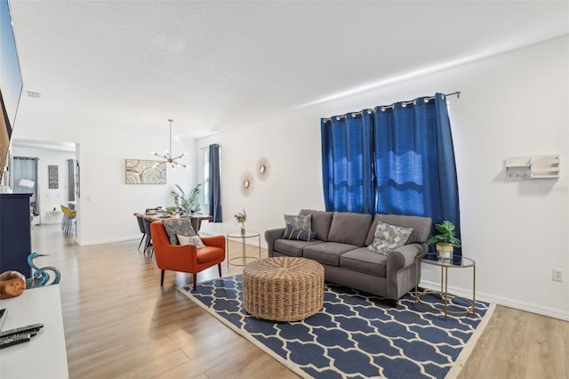 living room with wood-type flooring and a chandelier