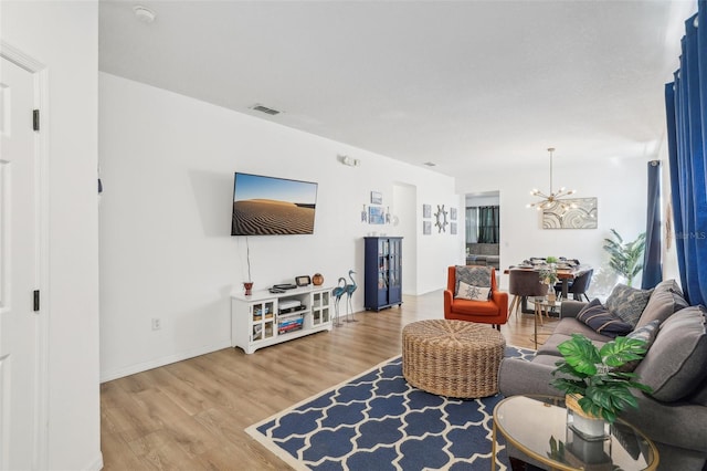 living room featuring wood-type flooring and a chandelier