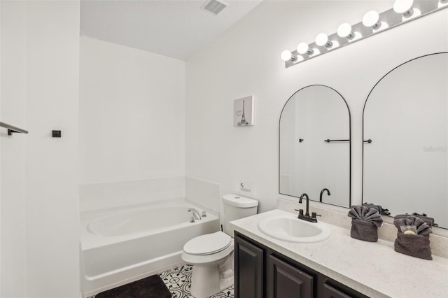 bathroom with tile patterned flooring, vanity, a tub, and toilet