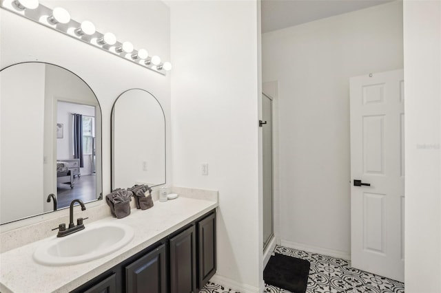 bathroom with tile patterned floors, vanity, and a shower with door