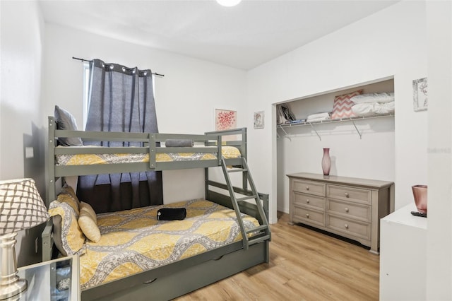 bedroom featuring a closet and light wood-type flooring