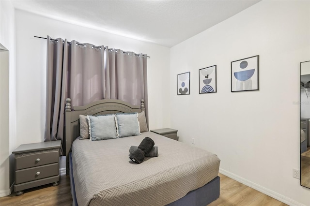 bedroom with wood-type flooring