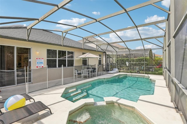 view of pool featuring an in ground hot tub, a lanai, and a patio area