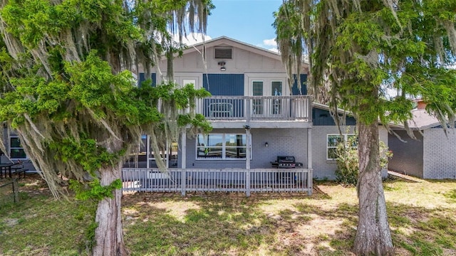 1149 Shady Cove Rd E, Haines City, FL 33844 - back of property featuring a balcony and brick siding