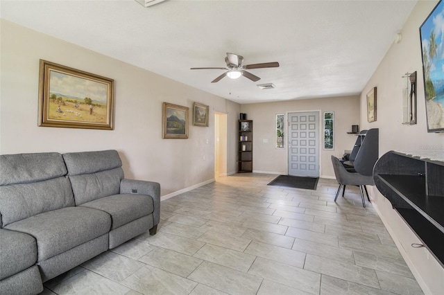 tiled living room featuring ceiling fan