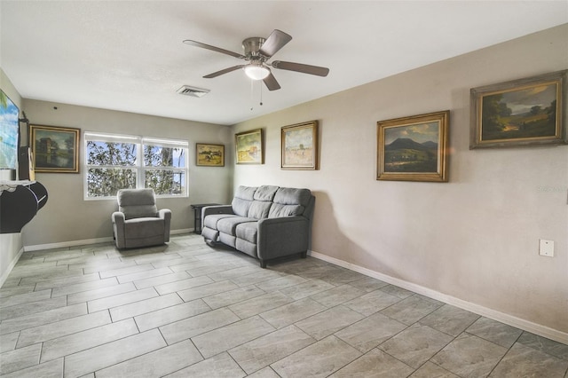 living area with tile floors and ceiling fan