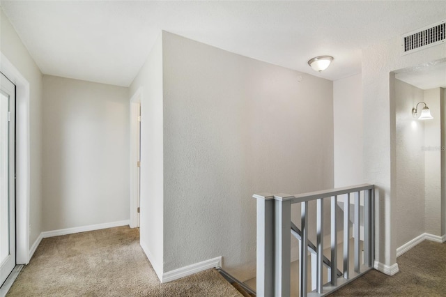 1149 Shady Cove Rd E, Haines City, FL 33844 - hallway featuring an upstairs landing, carpet, baseboards, and a textured wall