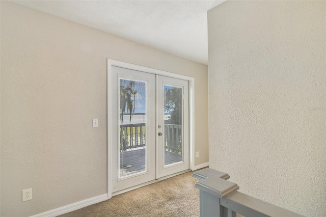 1149 Shady Cove Rd E, Haines City, FL 33844 - entryway with carpet, french doors, a textured wall, and baseboards