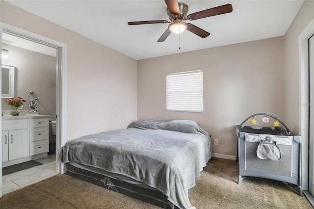 carpeted bedroom featuring ceiling fan and connected bathroom