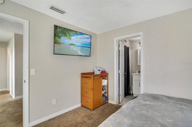 carpeted bedroom featuring connected bathroom