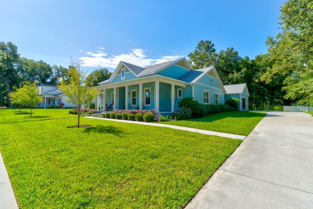 view of front of property with covered porch and a front yard