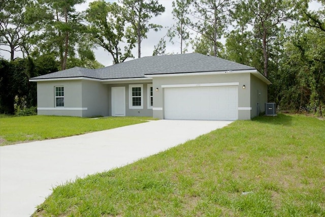 ranch-style house featuring a front lawn, central AC, and a garage