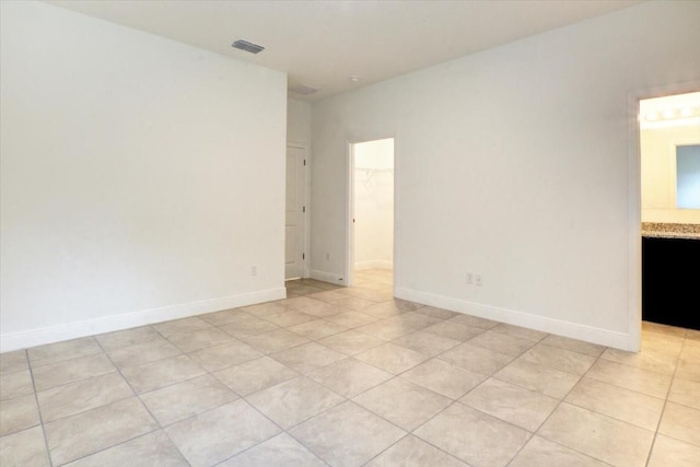 unfurnished room featuring light tile patterned floors