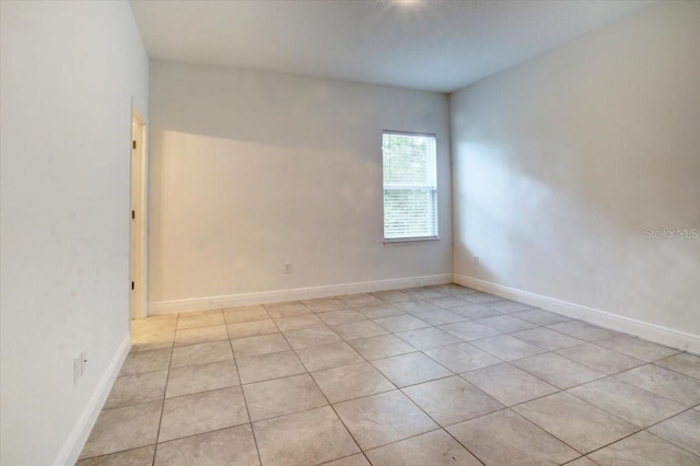 spare room featuring baseboards