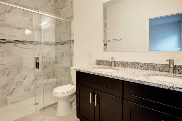 bathroom featuring vanity, toilet, an enclosed shower, and tile patterned floors