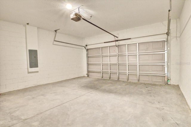 garage with electric panel and a garage door opener