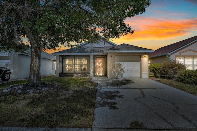 2519 Woods Edge Cir, Orlando, FL 32817 - ranch-style home with an attached garage, driveway, a shingled roof, and stucco siding