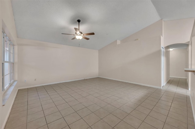 2519 Woods Edge Cir, Orlando, FL 32817 - empty room featuring lofted ceiling, a ceiling fan, baseboards, and light tile patterned floors