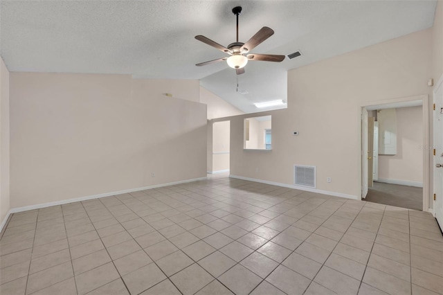 tiled spare room with lofted ceiling, a textured ceiling, and ceiling fan