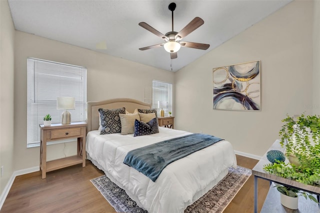 bedroom featuring lofted ceiling, wood-type flooring, and ceiling fan