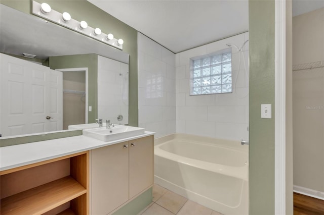 bathroom featuring vanity, tile patterned flooring, and tiled shower / bath combo