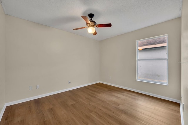 2519 Woods Edge Cir, Orlando, FL 32817 - spare room featuring baseboards, a ceiling fan, wood finished floors, and a textured ceiling