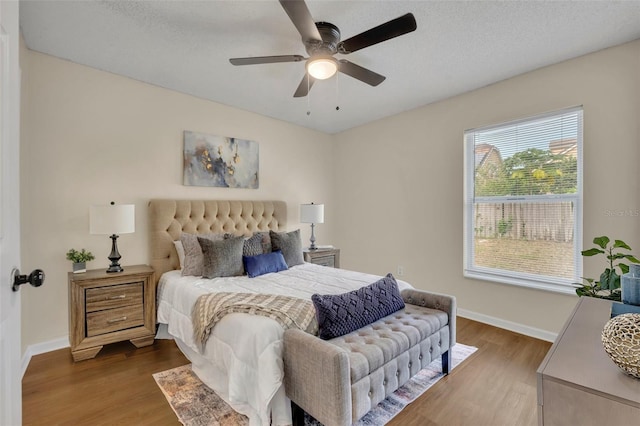 2519 Woods Edge Cir, Orlando, FL 32817 - bedroom with baseboards, a ceiling fan, and wood finished floors