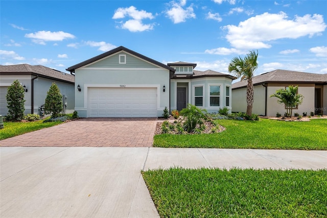 view of front of home featuring a front yard and a garage