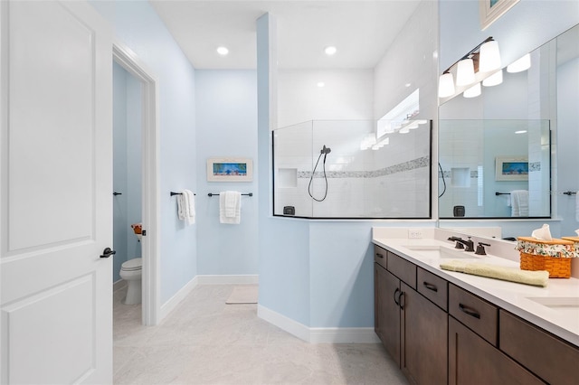 bathroom featuring tile patterned flooring, vanity, toilet, and tiled shower