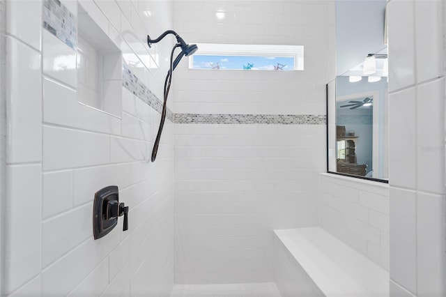 bathroom with tiled shower and ceiling fan