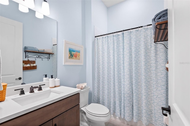 bathroom with vanity, toilet, and curtained shower