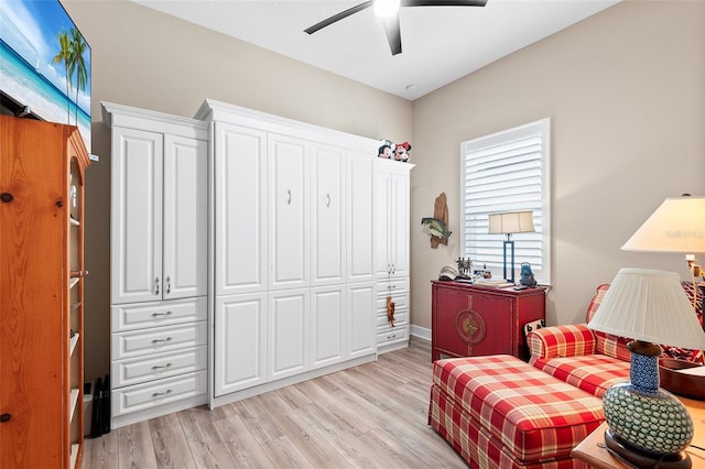 living area featuring light hardwood / wood-style flooring and ceiling fan