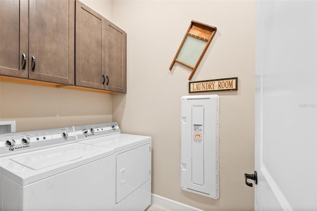 laundry area featuring washer and dryer and cabinets