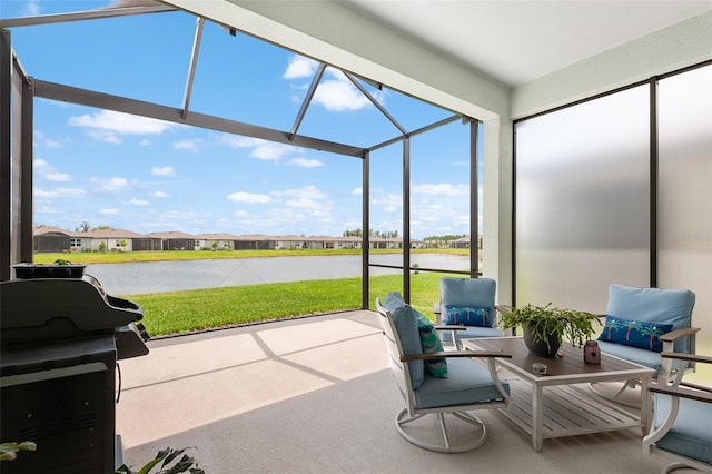 sunroom / solarium featuring a water view