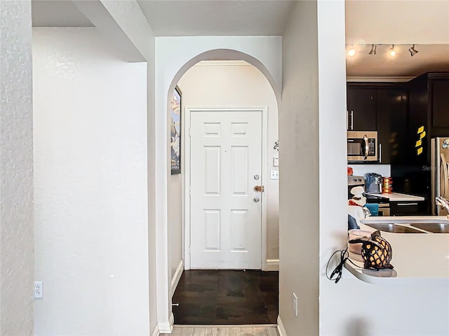 foyer entrance featuring hardwood / wood-style flooring and track lighting