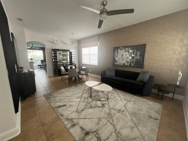 tiled living room with ceiling fan