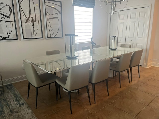 dining area with a chandelier and tile flooring