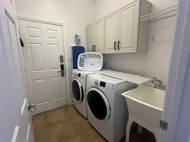 clothes washing area with cabinets, sink, independent washer and dryer, and tile floors