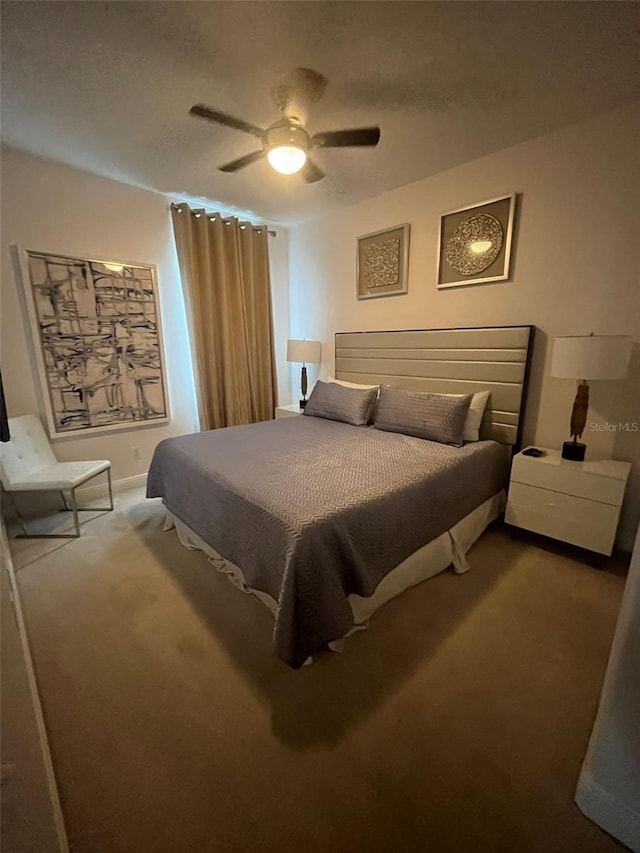 bedroom with ceiling fan and carpet floors