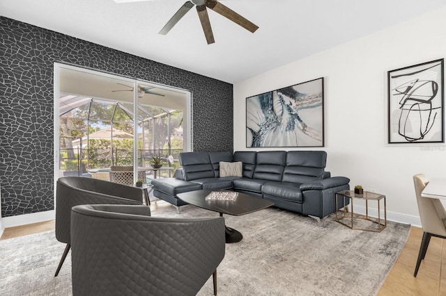 7416 Soiree Way, Reunion, FL 34747 - living room with an accent wall, wallpapered walls, a ceiling fan, wood finished floors, and a sunroom