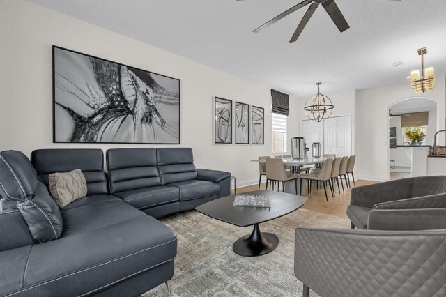 7416 Soiree Way, Reunion, FL 34747 - living room featuring a chandelier, a ceiling fan, and tile patterned floors